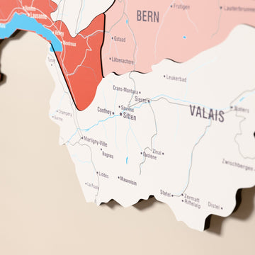 İsviçre ahşap haritasında bayrak renkli katmanlı bölgeler ve isimler, yakın plan