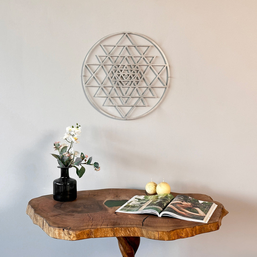 Gümüş Sri Yantra kutsal geometri metal duvar tablosu, ahşap konsolun üzerindeki duvarda